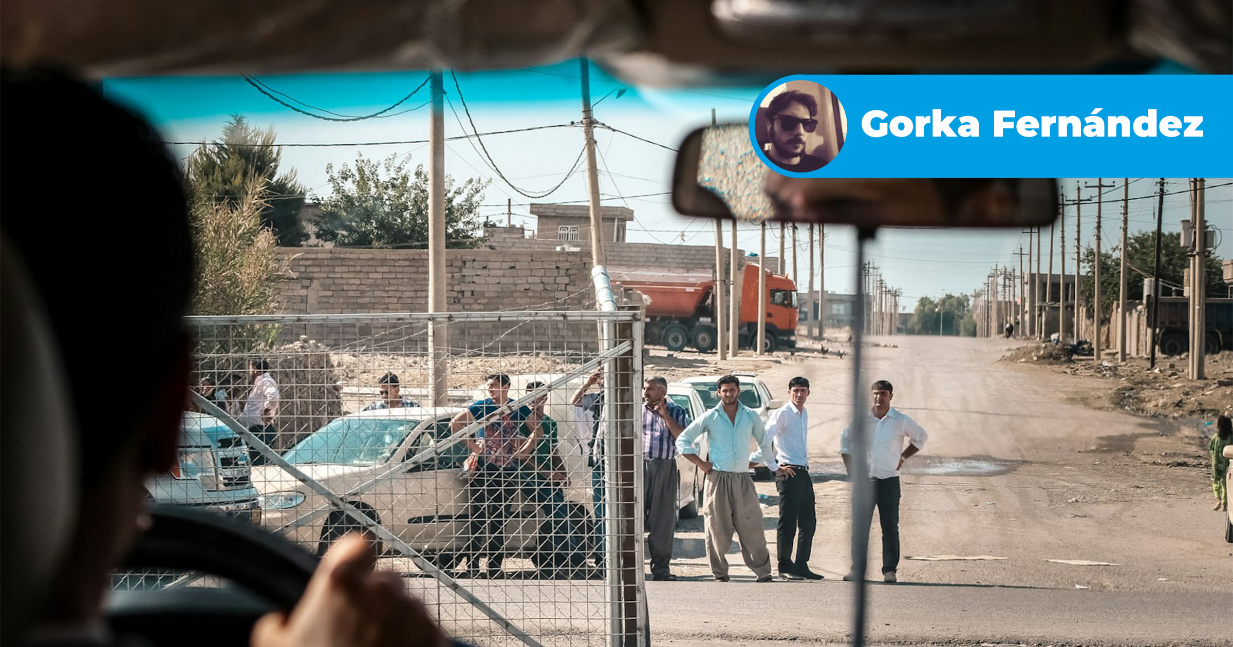 a group of men standing on the side of a road